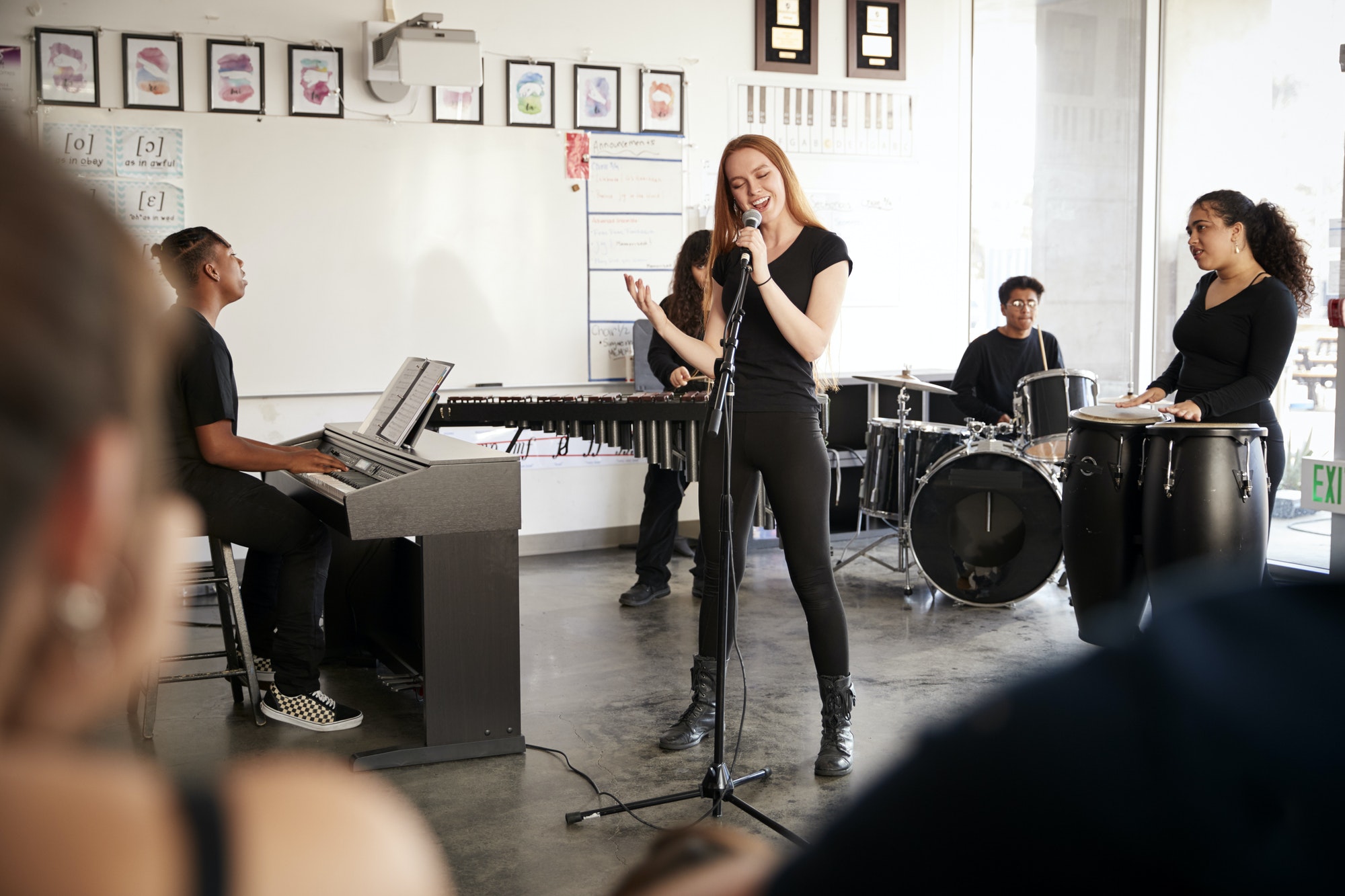 Students At Performing Arts School Playing In Band At Rehearsal