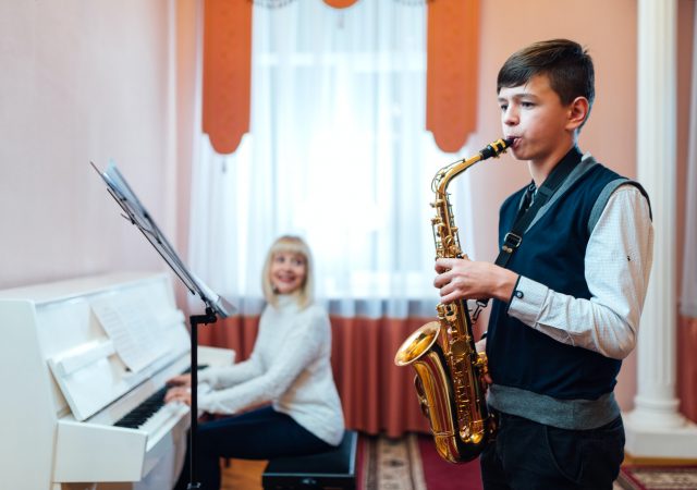 boy-learns-to-play-the-saxophone-in-a-music-lesson.jpg